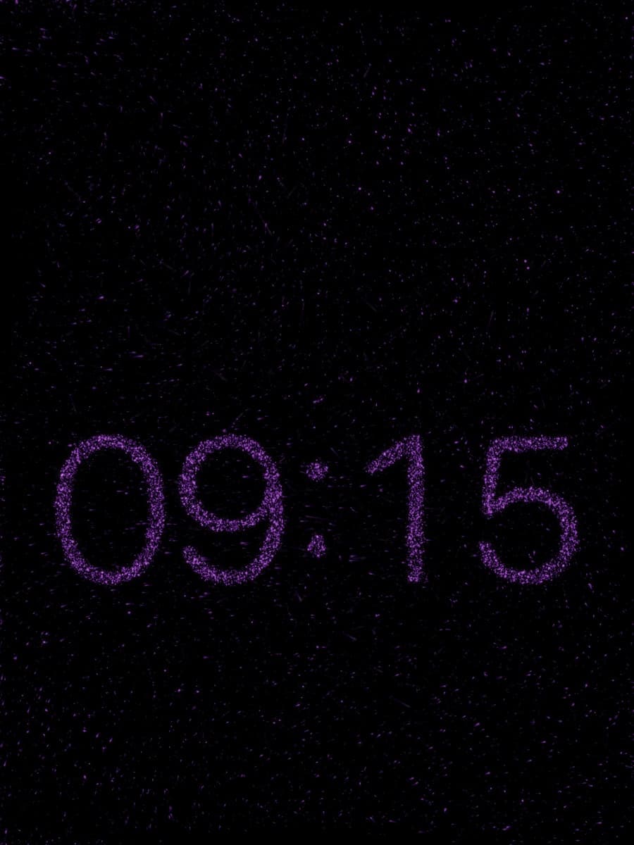 The particle clock drawing the time on a dark screen